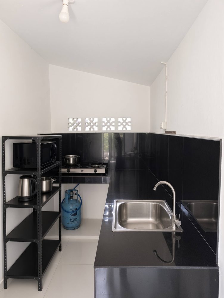 Black and white kitchen with sink and open shelving
